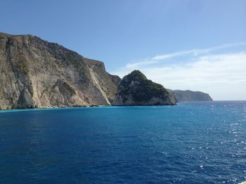 Scenic view of sea and mountains against sky