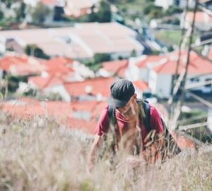 High angle view of mature man climbing on mountain