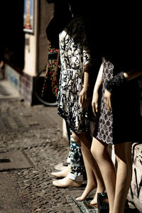 Low section of woman standing on street