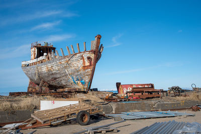 Old rusty ship against blue sky