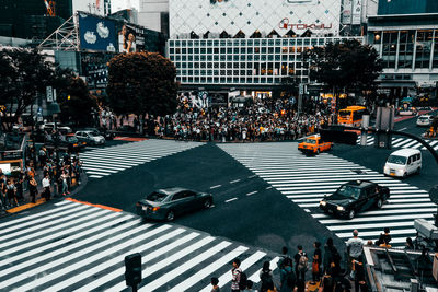 Group of people crossing road in city