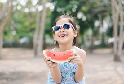 Cute smiling girl holding watermelon