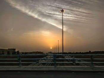 Street lights against sky during sunset