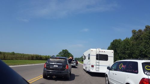 Cars on road against sky