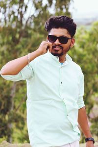 Young man wearing sunglasses standing outdoors