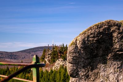 Rock formations on landscape against blue sky