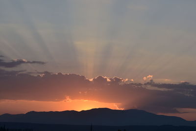 Sunlight streaming through clouds during sunset