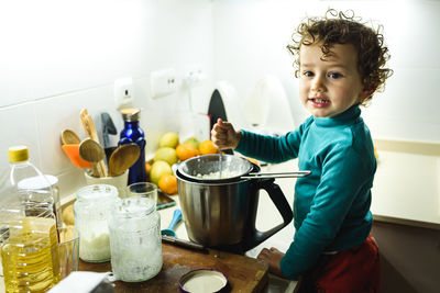 Cute girl preparing food at kitchen