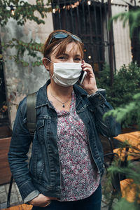 Portrait of young woman standing outdoors