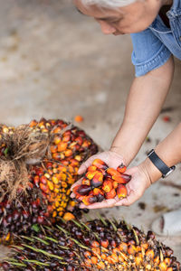 Woman holding fruits while standing outdoors