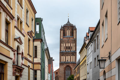 Traditional colorful houses and church tower in the old town of stralsund.