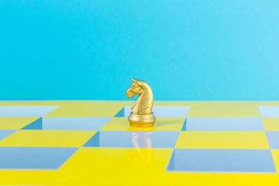 High angle view of chess pieces against blue background