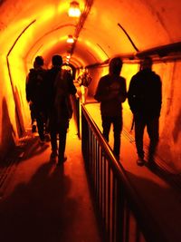 Rear view of silhouette people walking in corridor