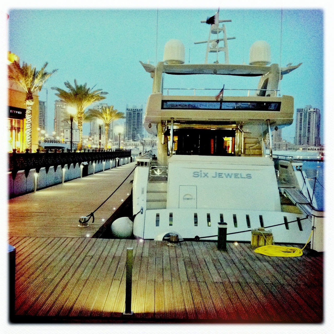 transfer print, auto post production filter, moored, nautical vessel, transportation, water, boat, mode of transport, sea, sky, sunlight, harbor, day, outdoors, built structure, building exterior, clear sky, no people, absence, tree