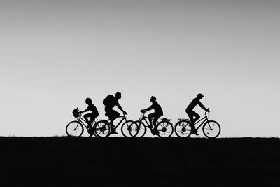 Silhouette of bicycles against clear sky