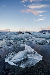 Scenic view of frozen lake against sky during winter