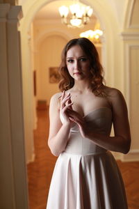 Portrait of smiling beautiful young woman wearing dress