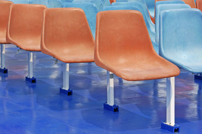 Empty chairs and tables in swimming pool