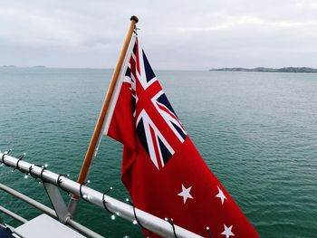 Close-up of flag against sea