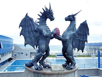 Statue of people in front of building