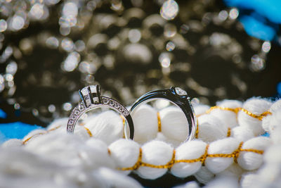 Close-up of wedding rings amidst decoration on table