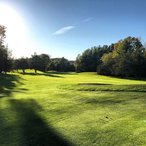 Scenic view of golf course against sky