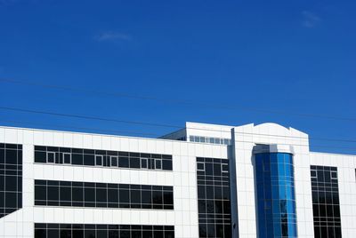 Low angle view of building against blue sky