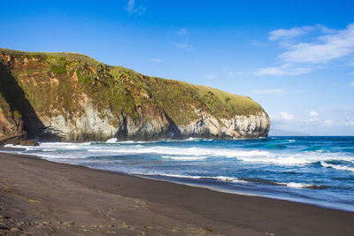 Scenic view of beach against blue sky