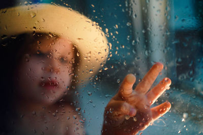 A girl in a straw hat, rain outside the window