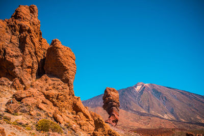 View of rock formation against clear blue sky