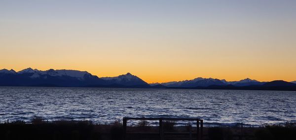 Scenic view of sea against clear sky during sunset