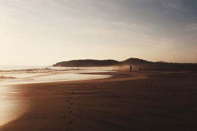 Scenic view of beach against sky during sunset