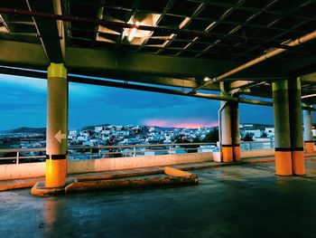 Bridge over river against sky in city