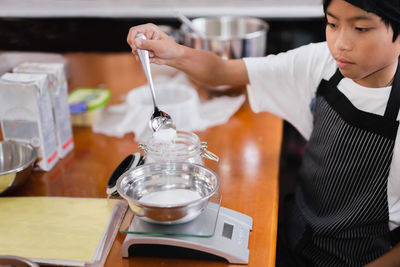 Side view of man drinking glass on table