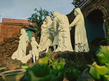 Low angle view of statue against plants