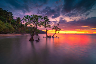 Scenic view of sea against romantic sky at sunset