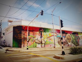 Graffiti on wall in city against sky