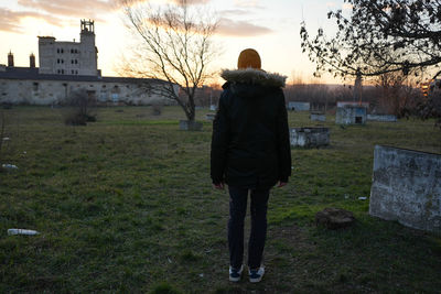 Rear view of man walking on field