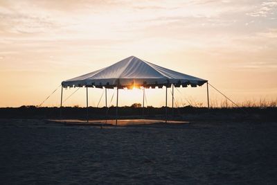 Lifeguard hut on sea against sky
