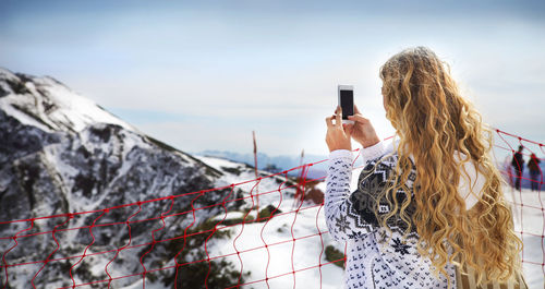 Woman photographing with mobile phone