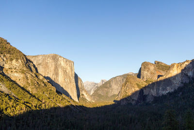 Scenic view of mountains against clear blue sky