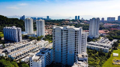 High angle view of modern buildings in city against sky