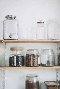 Dried fruits in jars arranged on shelves at shop