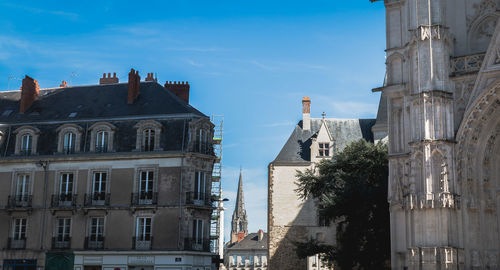 Low angle view of buildings in city against sky