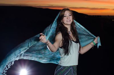 Young woman looking away against bright sun