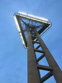 Low angle view of communications tower against blue sky