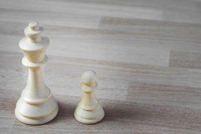 Close-up of chess pieces on wooden table