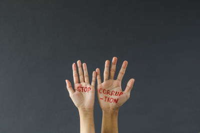 Close-up of woman hand against black background