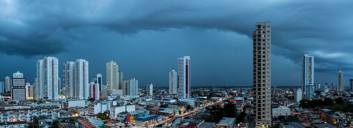 Panoramic view of buildings in city against sky