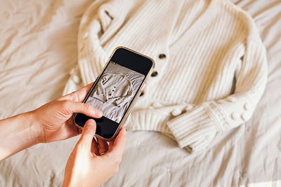 Midsection of woman using mobile phone